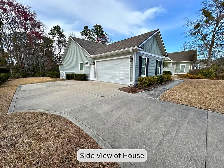Double car garage with separate entry and additional paved parking