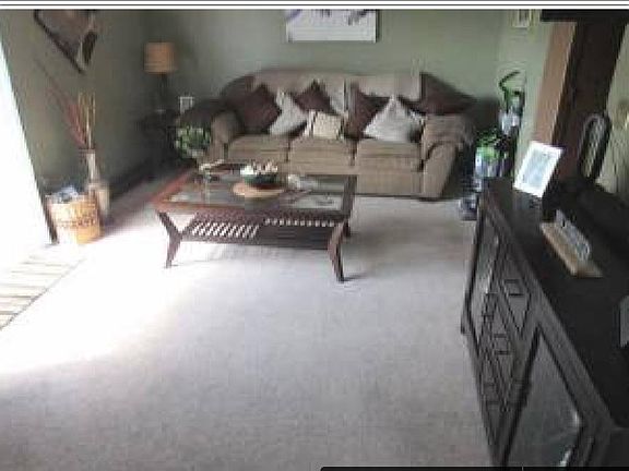large living room with slider door to private deck