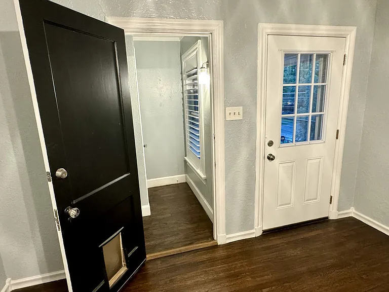 View from the dining room, looking out at the private porch (on the right) and the door (left) leading downstairs to the front door entrance.
