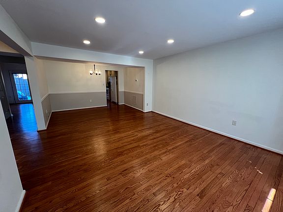 Open dining room/living room w/ recessed lighting and hardwood floors