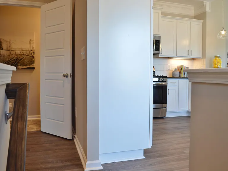 Straight ahead is the second powder room. To the right, the space opens up to the main living area of the house.