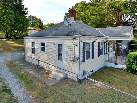 Gravel driveway leads to private lot in the back