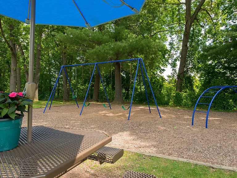 Our community offers a delightful picnic area with an umbrella-shaded table to relax, while kids can explore the on-site playground.