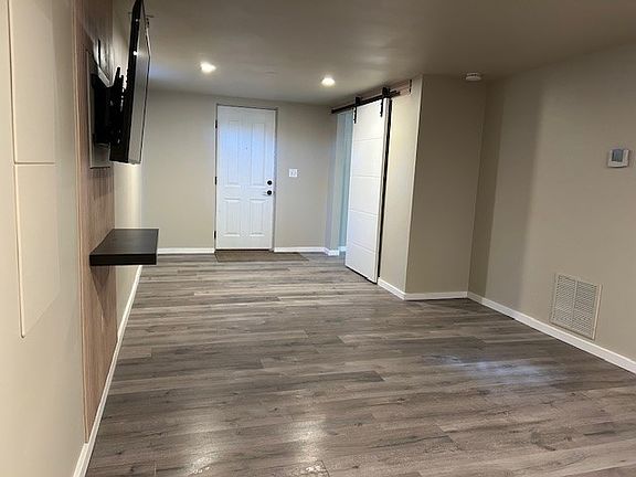 Dining space looking back at front door, sliding bedroom door to the right.