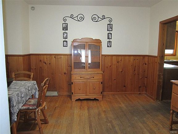 The Dining Room is spacious and situated between the Greatroom & Kitchen for ideal traffic flow.  It has been freshly painted and boasts real, solid, knotty pine wainscoting.