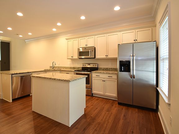The large open concept kitchen welcomes you into the home. Enjoy the extra tall ceilings throughout the first floor.