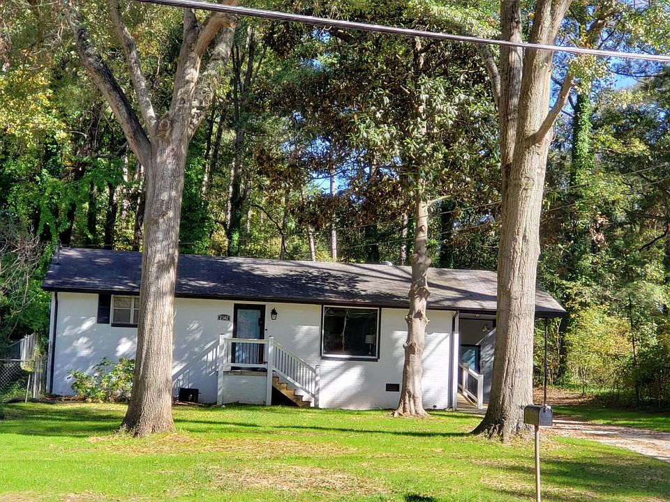 Exterior picture with large front yard and driveway long enough to park 3 cars