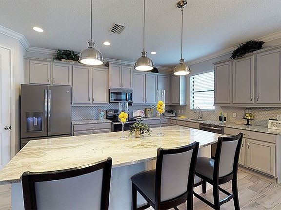 Juniper-FL Model Home - Beautiful Kitchen with Stainless Steel Appliances, Large Pantry, and Granit