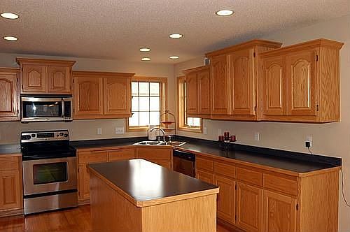 Center island, stainless steel appliances and ample and attractive cabinets