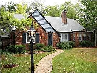 Front elevation - freshly painted exterior, beautiful landscaping, estate size