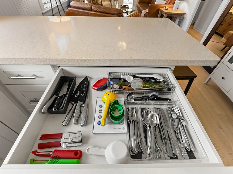 The kitchen is open to the living room and features plenty of storage and counter space, a ceiling fan, full size refrigerator with water station, oven, microwave and dishwasher. The kitchen is fully equipped.