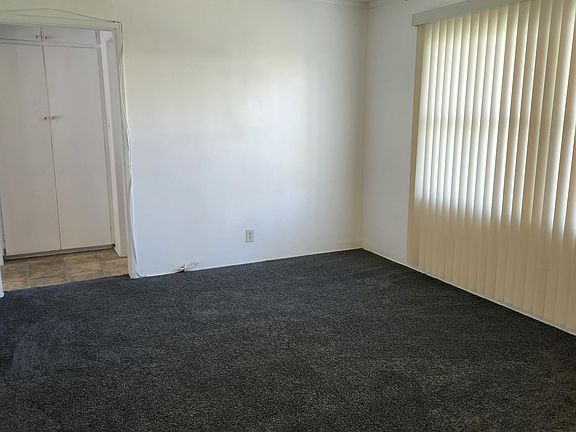 New carpet, blinds and ceiling fan in living room