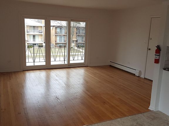 Large living room, new windows, balcony, hardwood floors