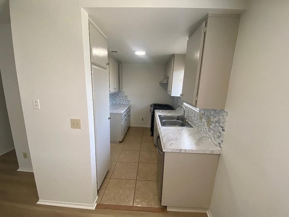 Kitchen with new stove and dishwasher.