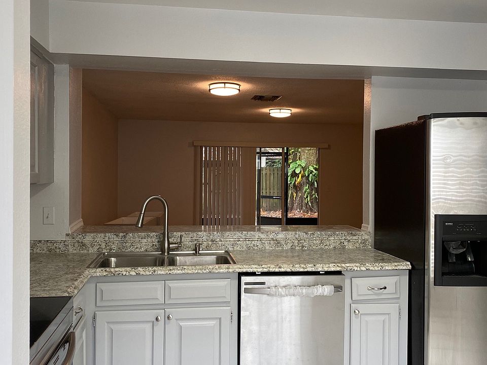 Open-concept kitchen with stainless steel appliances.