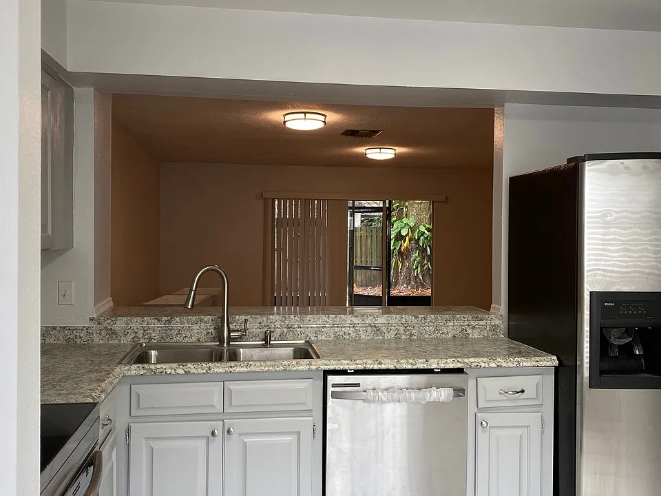 Open-concept kitchen with stainless steel appliances.