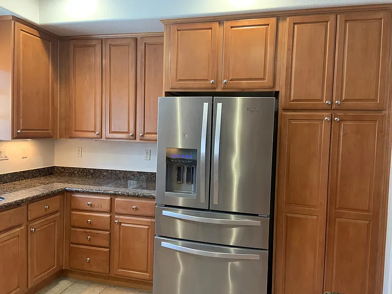 Newer refrigerator and lots of kitchen storage.