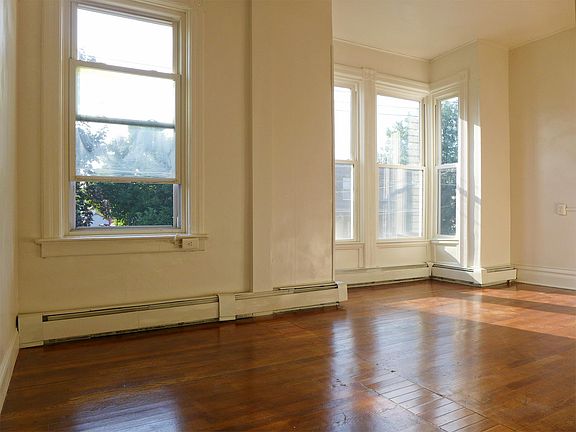 Master bedroom has tall windows and walk-in closet