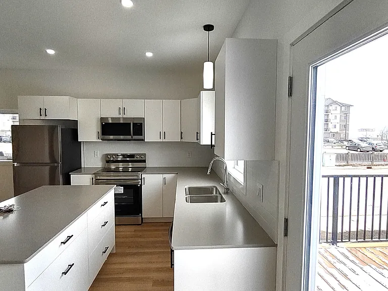 Side view of kitchen with Appliances
Fridge, Microwave, Stove and Island cabinets