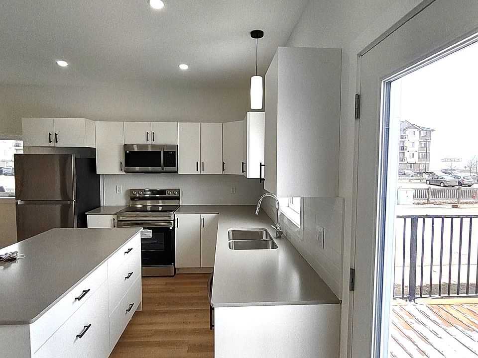 Side view of kitchen with Appliances
Fridge, Microwave, Stove and Island cabinets