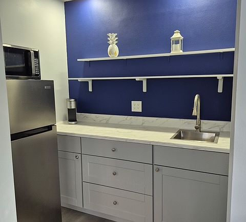Kitchenette with sink, private fridge, microwave and coffee maker