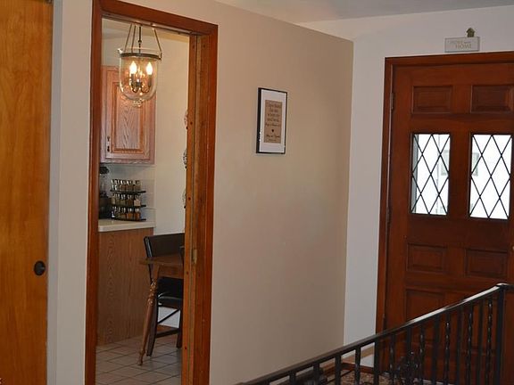 Double door closet for coats and shoes and entry into the eat-in kitchen.