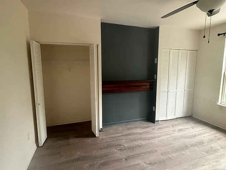 Bedroom 1 with beautiful flooring and large closets