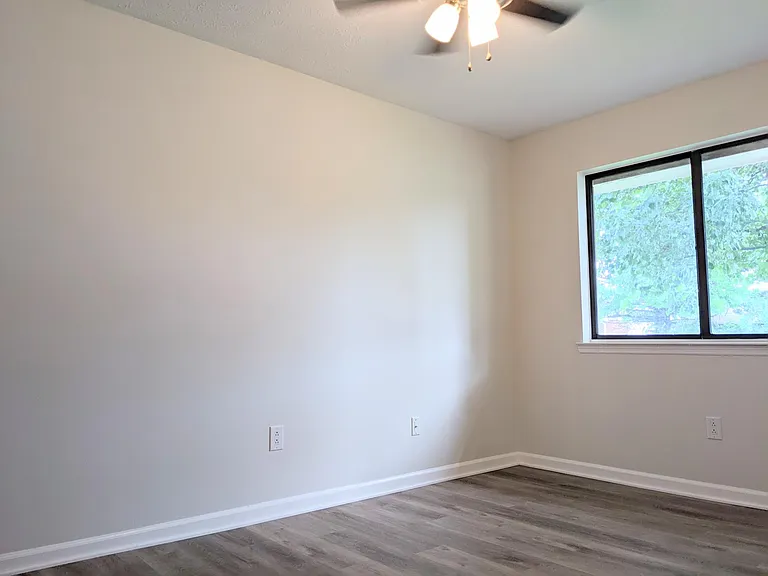 2nd Bedroom with ceiling fan and large window. (view from entry door)