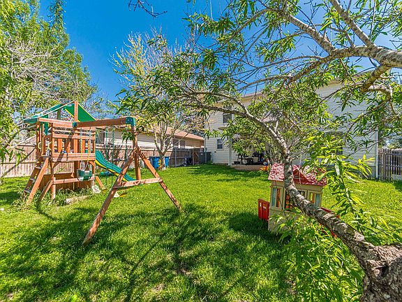 Large backyard with mature trees for lots of shade and play area for kids.