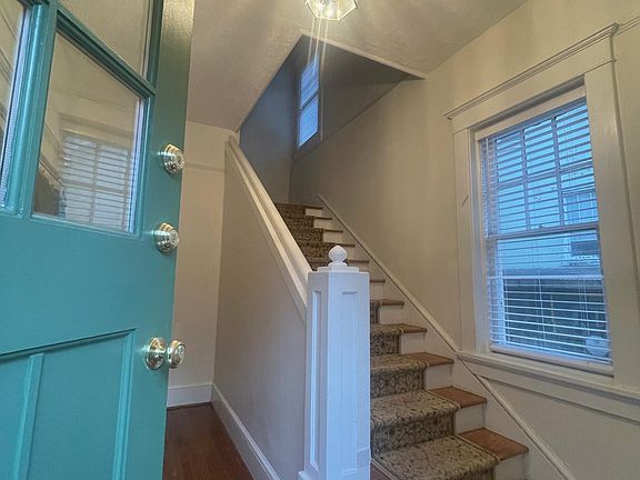 Front door (now blue) and stairs to apartment, foyer is private to apartment, great for bikes!