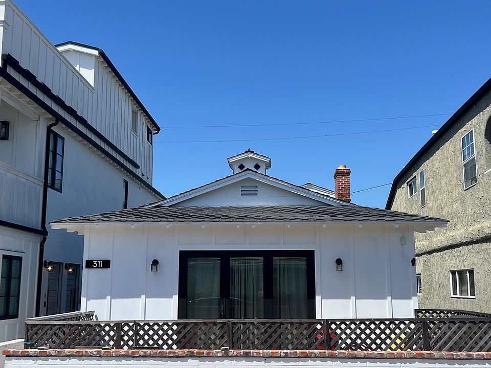 Original 1955 Beach Cottage with beautiful new glass doors that open to a custom brick patio