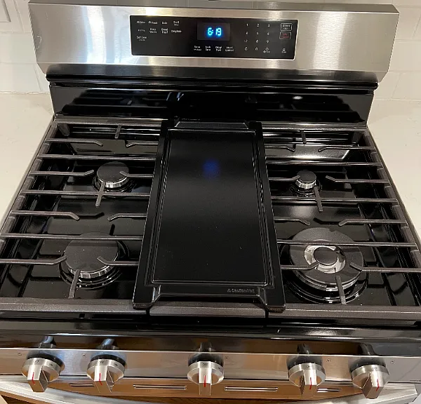 Beautiful kitchen with gas stove, mounted microwave, and dishwasher.