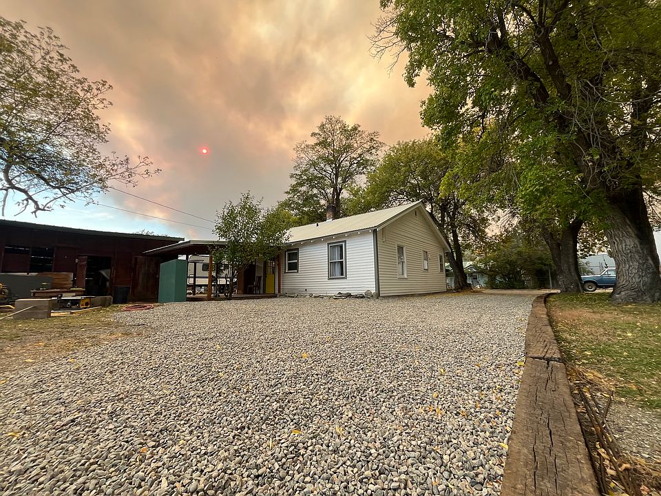 Ample parking and gravel driveway along side of house.