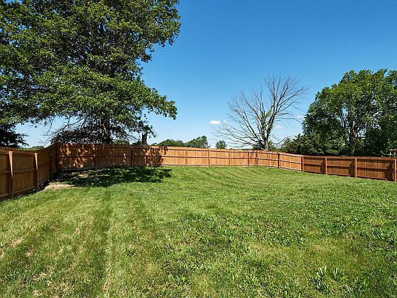 Fenced in yard backing to open ground.