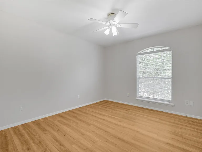 2nd floor bedroom featuring lots of light and ceiling fan