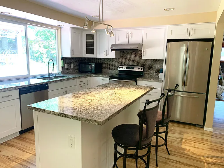 Built in island in kitchen with marble counter top