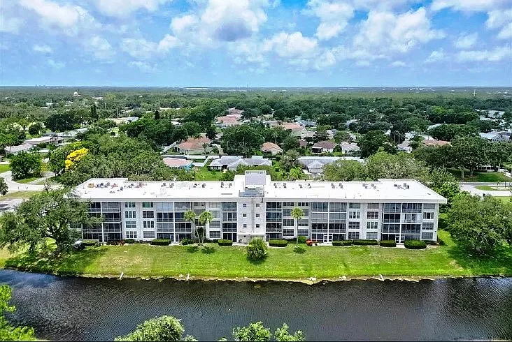 Westerly aerial view of our building and beyond. Our building is the tallest building (4 stories) permitted within the developed Palm Aire community. The elevation of our condo provides the expansive area views we enjoy.