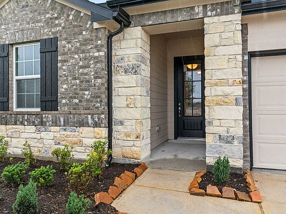 The beautiful entryway greets you with inviting stone and brick exterior.