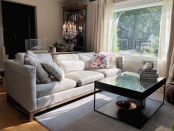 Living room with a sunny picture window. Italian linen drapes and sheers included.