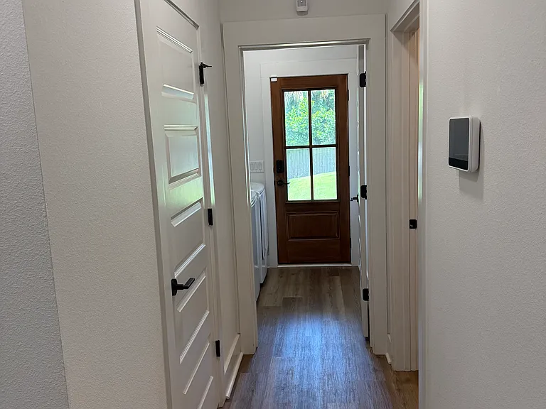 Back hallway with bathroom on left and laundry straight ahead