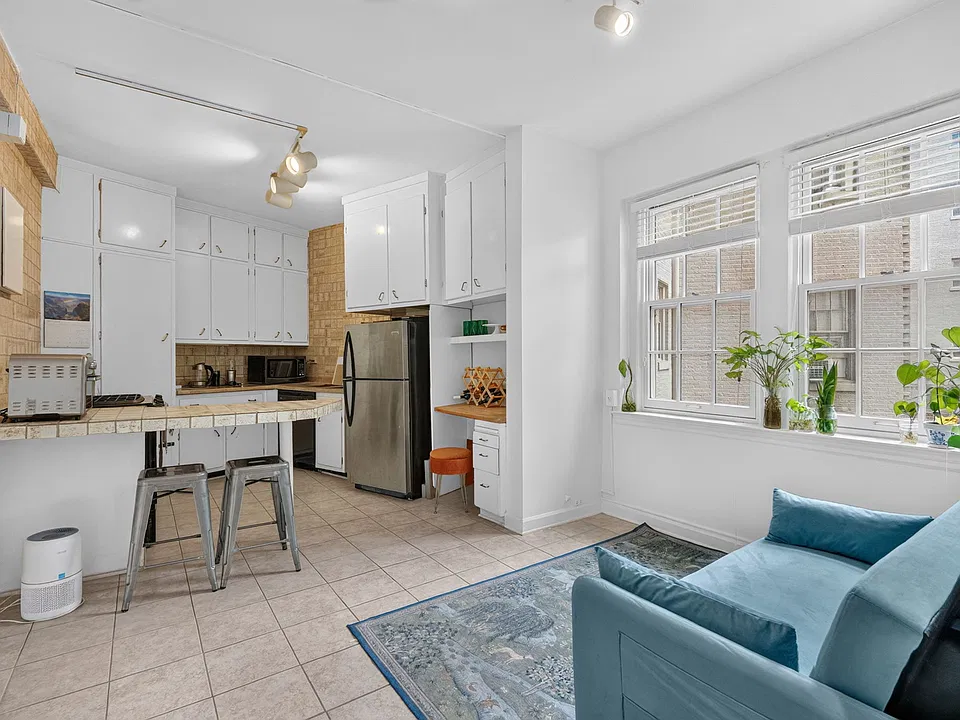 Spacious Kitchen with stools & living area