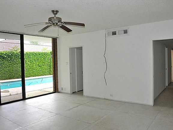 Large master bedroom with sliding glass doors with access to backyard.