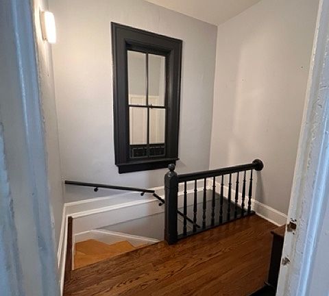 This unit is on the second floor. Entryway features a custom mirror which has been installed within the window frame.