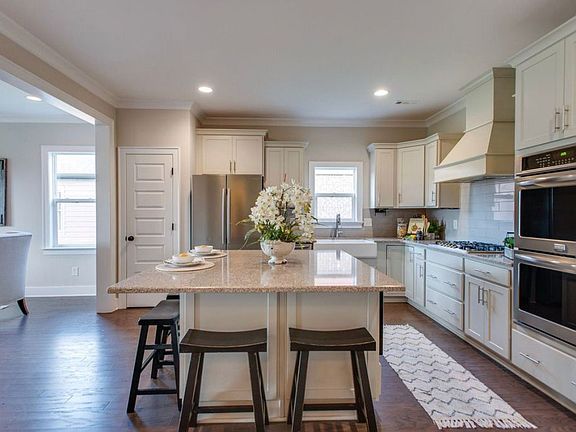 Kitchen with Lage island and stainless-steel appliances, 5-burner gas stove, Double oven range, large sink, pantry, microwave etc.