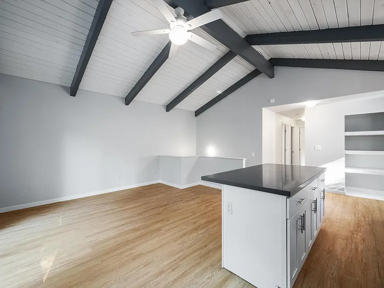 Updated bright & open concept kitchen with quartz counter tops, stainless appliances & vaulted ceilings. Built-ins for handy storage.
