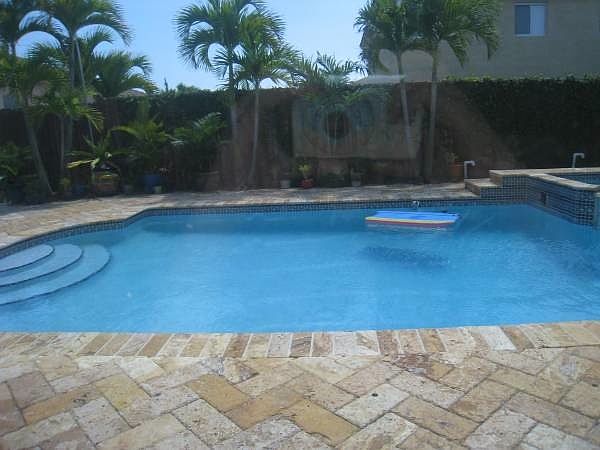 Pool with travertine pavers all around