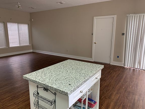 View of family room from kitchen. Door goes to attached garage. Flooring is wood look vinyl plank