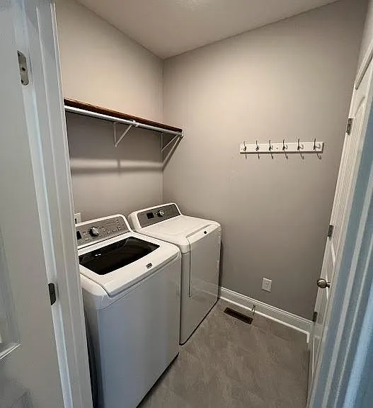 Laundry room with closet and washer and dryer