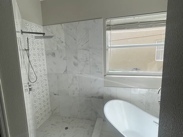 Master Bath tub and shower. Full marble shower and bath surrounding
