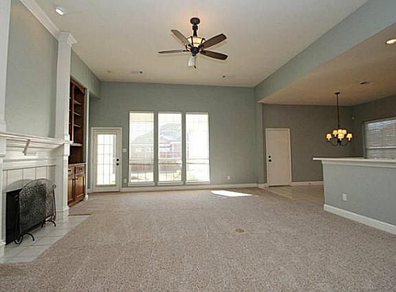 Open floor plan with extended bar counter and fireplace with gas logs.